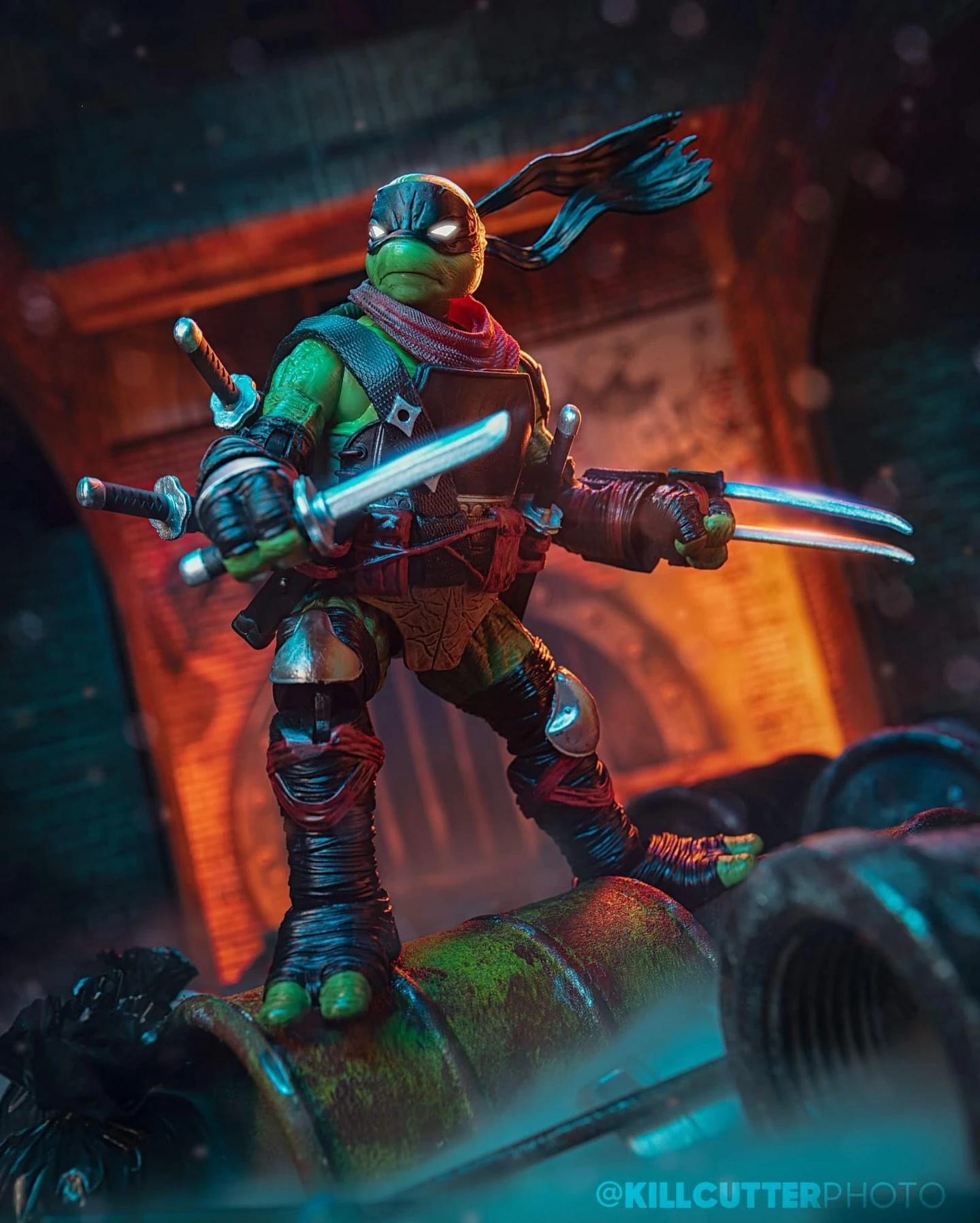 Dark Leonardo action figure on a sewer pipe with swords drawn, lit orange and teal with steam behind him