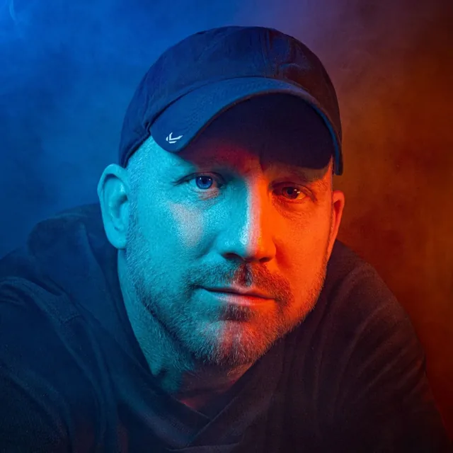 Portrait of Chuck Eiler, lit with blue and orange rim light