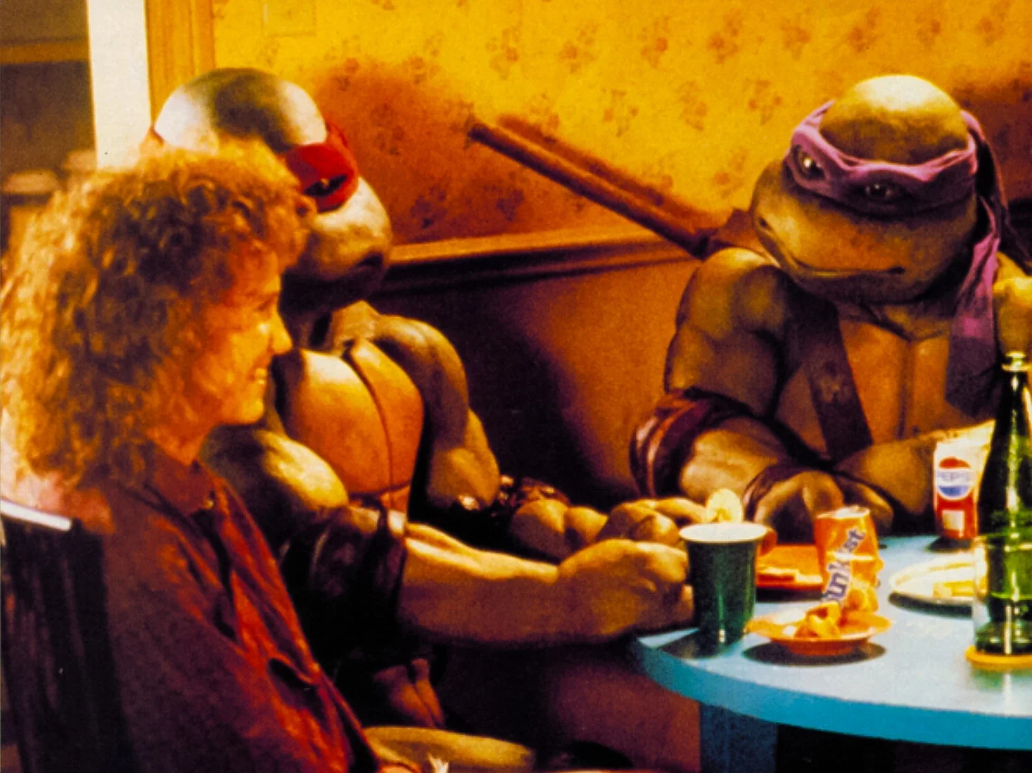 April shares dinner with the Turtles in the lair.