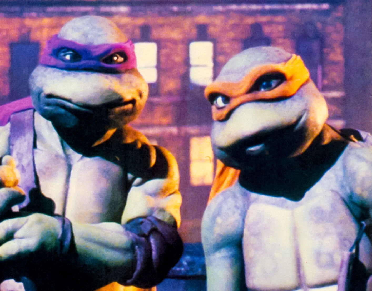 Donatello and Michelangelo against the city skyline.
