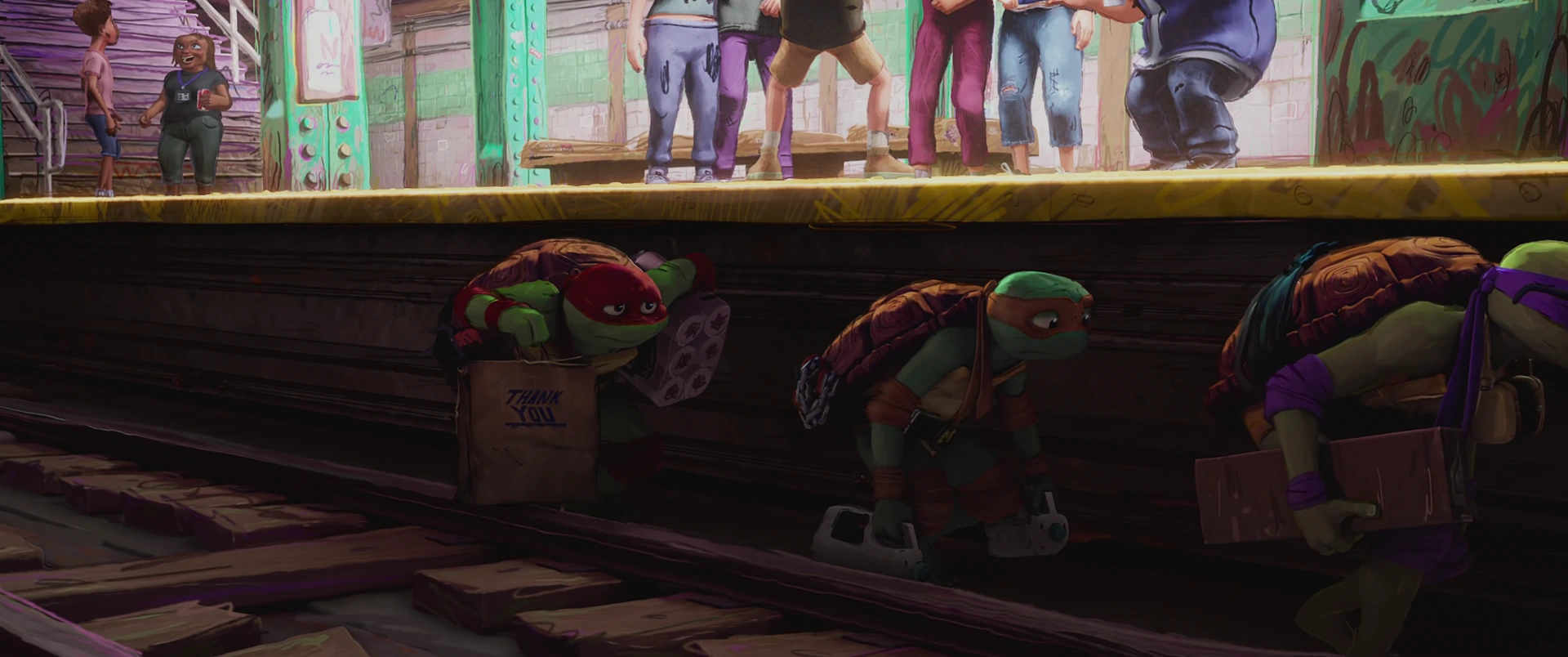 Three Turtles crouch low on subway tracks beneath a platform edge while commuters’ legs pass above them.