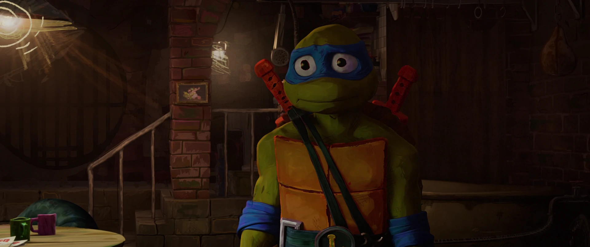 Leonardo stands alone in the sewer lair looking sheepish, his blue mask and crossed katanas clearly visible.