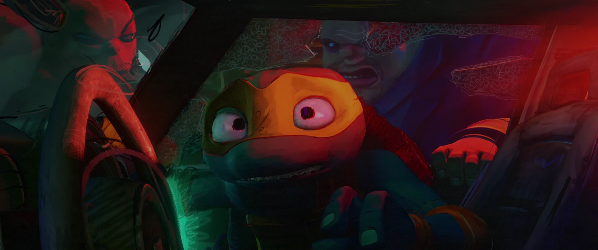 Michelangelo stares wide-eyed through a windshield as a red-skinned mutant grips the steering wheel beside him.