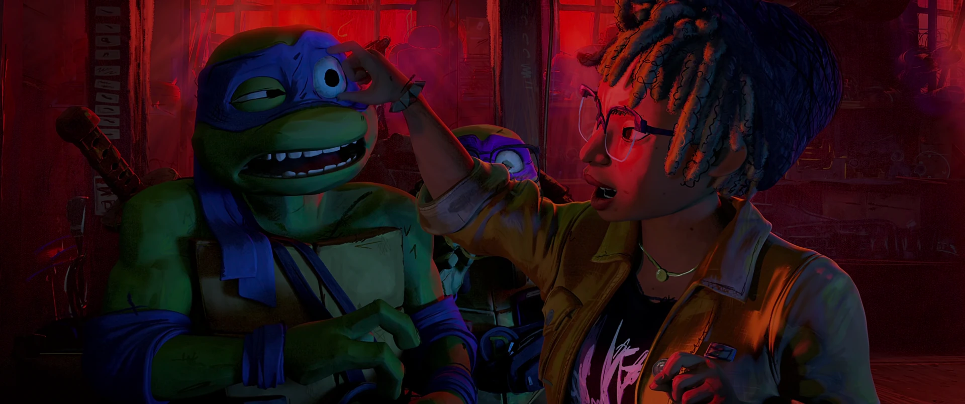 April reaches out to touch Leonardo’s face while Donatello watches from behind, all bathed in warm red light.