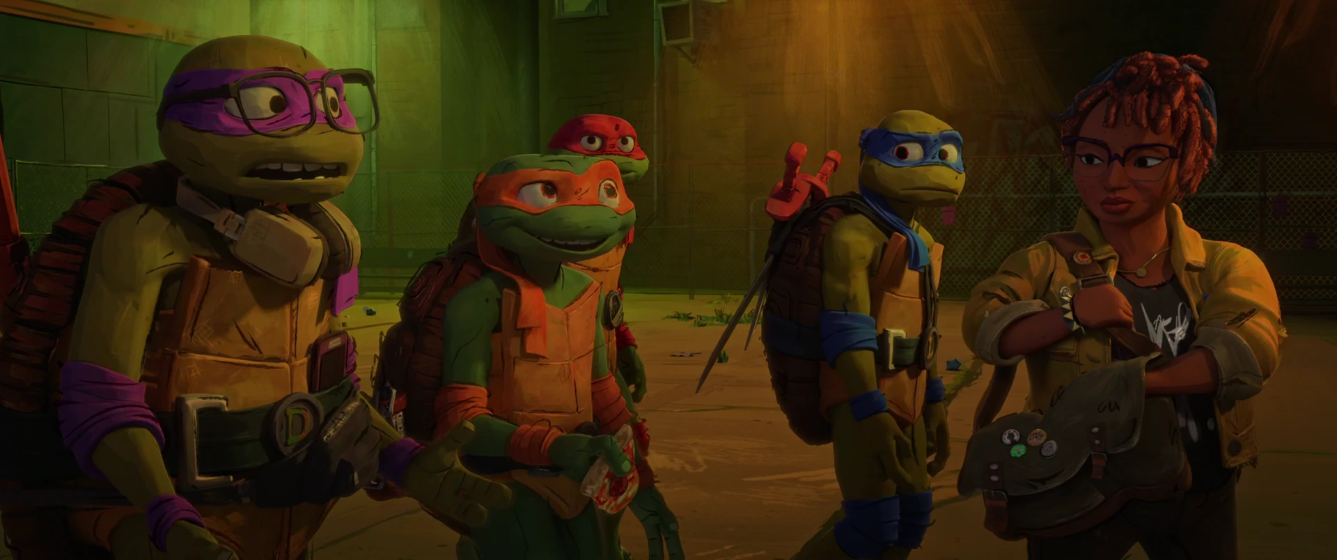 Donatello, Michelangelo and Leonardo stand beside April under warm amber light, looking at her.