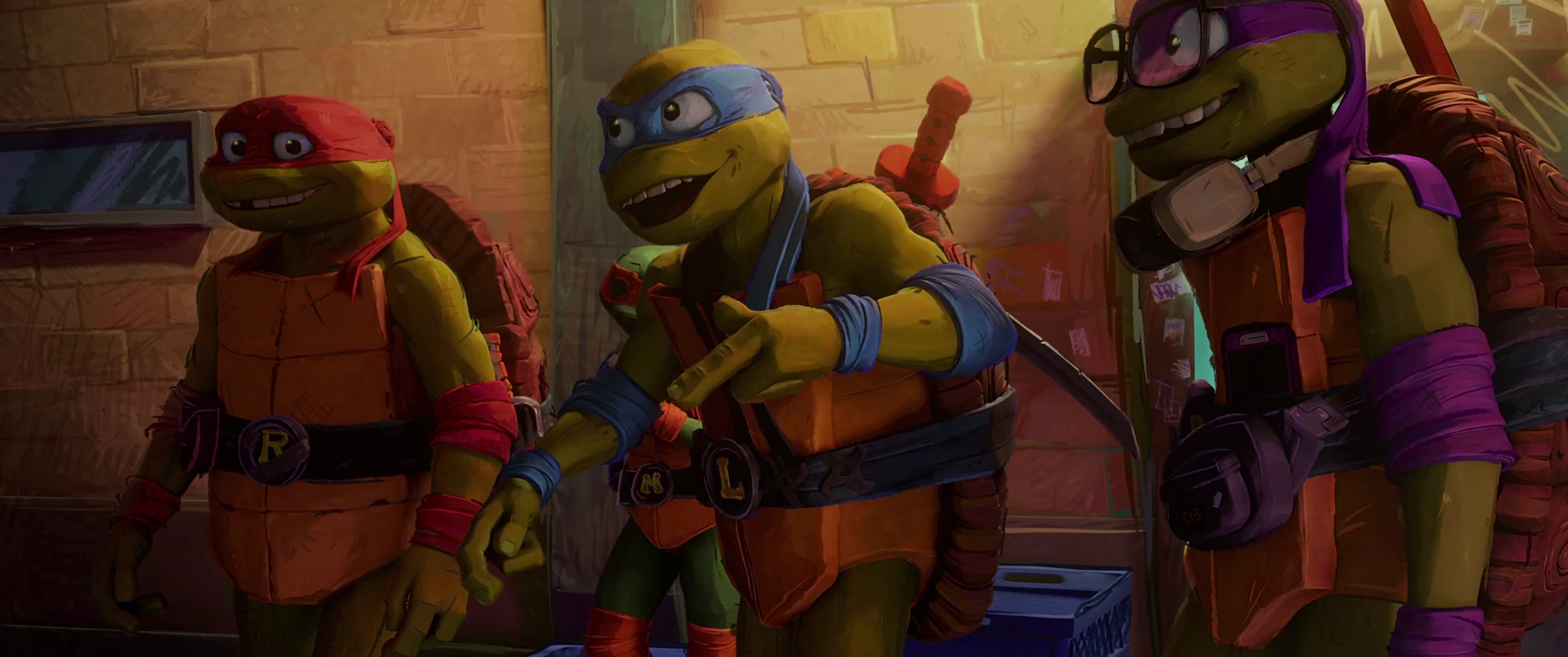 Leo, Raph and Donnie stand against a brick alley wall in warm light, looking excited and pumped up together.