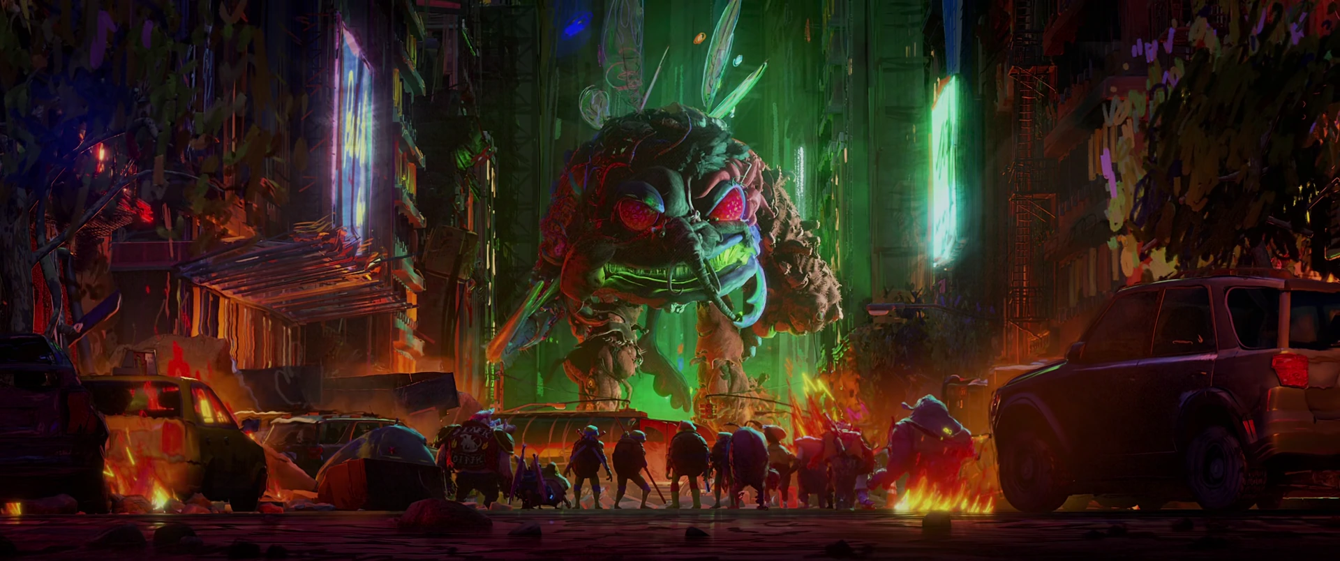 The Turtles and mutant allies stand tiny against the towering Superfly kaiju amid a burning street at night.